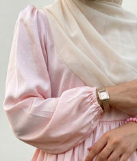 Close-up of blush pink silk sleeve with balloon cuff, modest outfit detail