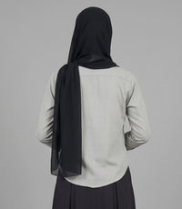 Back view of grey button-down shirt and black pleated maxi skirt co-ord set with hijab